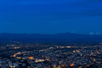 High angle view of illuminated buildings in city at night