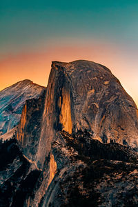 Scenic view of volcanic mountain against sky during sunset