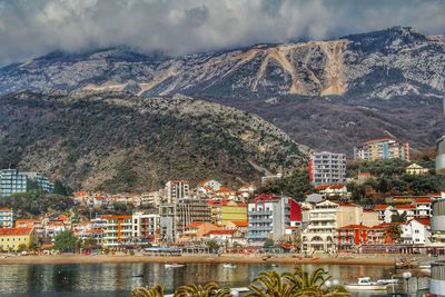 View of cityscape against cloudy sky