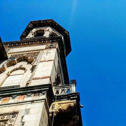 Low angle view of building against clear blue sky