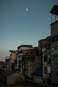 Buildings in city against clear sky