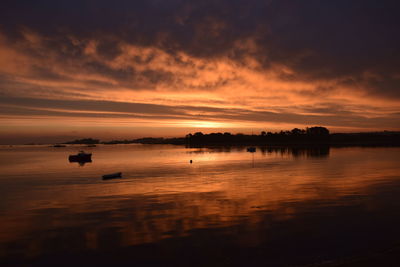 Scenic view of lake against orange sky