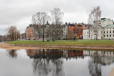 Reflection of trees and buildings in canal