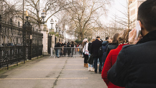 People standing in queue at parking lot