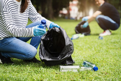 Low section of woman sitting on grass