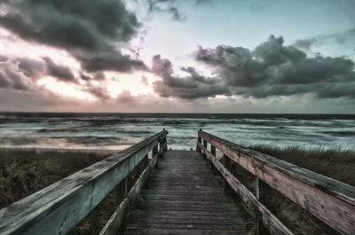 Pier over sea against sky