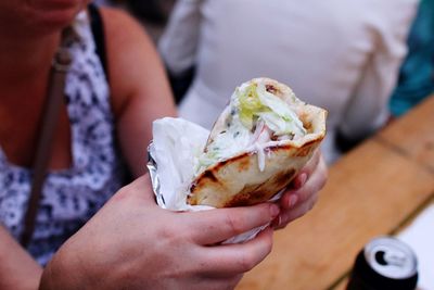 Close-up of woman holding wrap sandwich