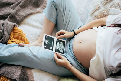 Midsection of woman using mobile phone