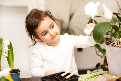 Portrait of smiling boy holding flowers