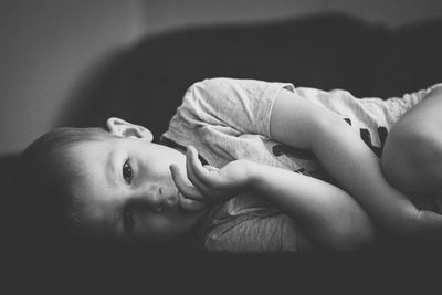 Portrait of cute baby lying on floor