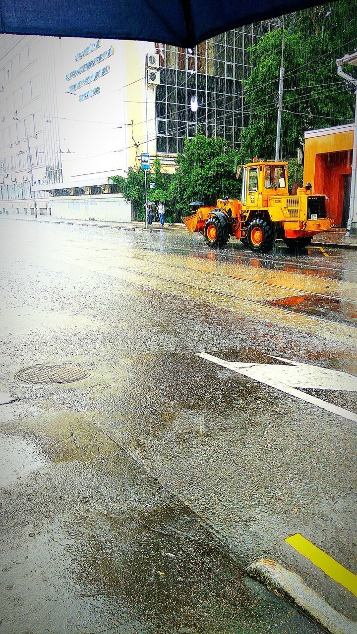 VEHICLES ON ROAD AGAINST CONSTRUCTION SITE