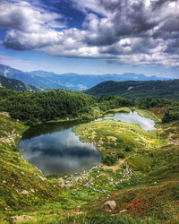 Scenic view of lake and mountains against sky