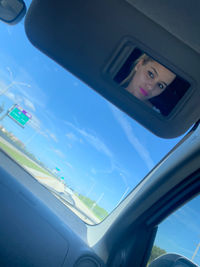 Portrait of woman seen through car window