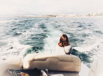 Woman sitting in boat on sea
