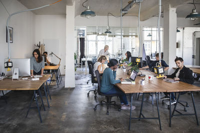 Multi-ethnic business people working at desks in office