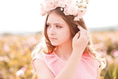 Teenager girl wearing wreath standing at farm
