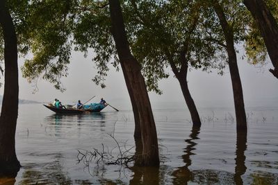 People on boat against sky