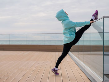 Low angle view of woman exercising on floor