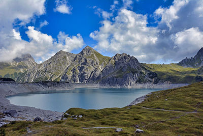 Scenic view of lake and mountains against sky