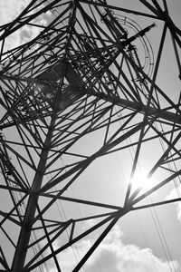 Low angle view of electricity pylon against sky