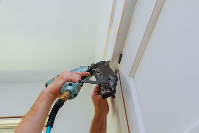 Midsection of man working on wall