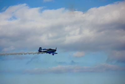 Low angle view of airplane flying in sky