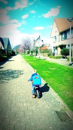 Boy riding motorcycle on street in city