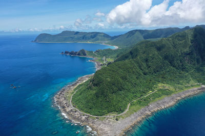 High angle view of sea and mountains against sky