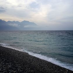 Scenic view of sea against cloudy sky