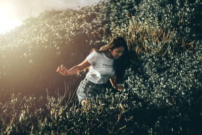 Smiling young woman on field