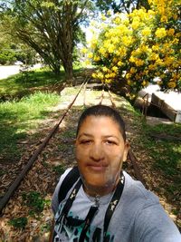 Portrait of smiling woman against plants