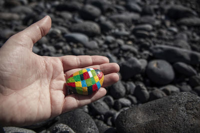 Close-up of human hand holding rock