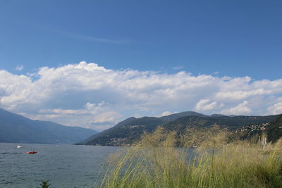 Scenic view of landscape and mountains against blue sky