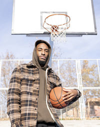 Man playing with basketball hoop