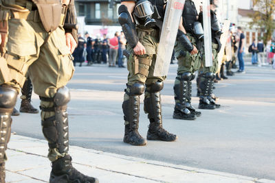 Low section of army soldiers standing on street
