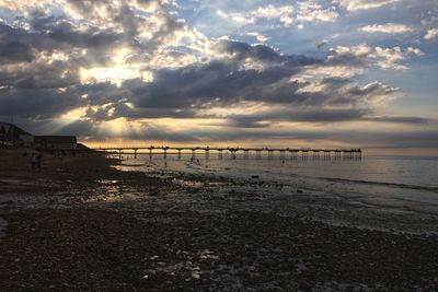 Scenic view of beach against sky during sunset