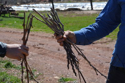 Men holding stick on field