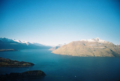 Scenic view of lake against clear blue sky