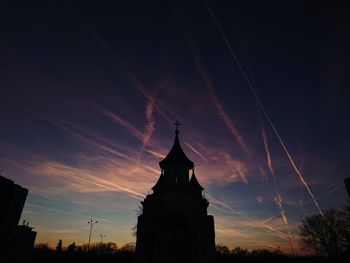 Low angle view of silhouette building against sky during sunset