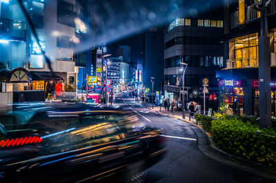 Light trails on road in city at night