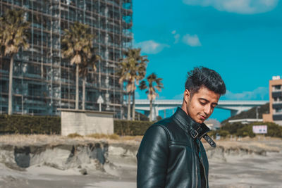 Man standing against sky in city