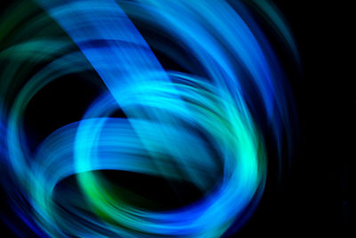 Abstract image of blue light against black background