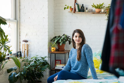 Portrait of woman sitting on table