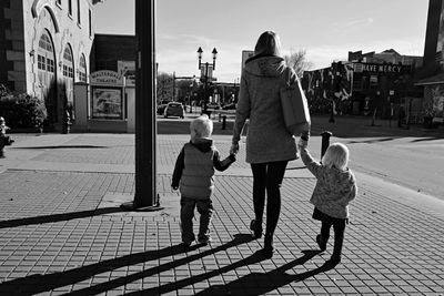 Rear view of women walking on street