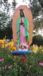 Low angle view of statue against trees