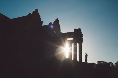 Silhouette angkor wat against sky