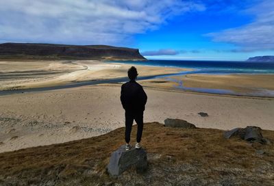 Rear view of man standing on beach