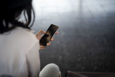 Midsection of woman using mobile phone