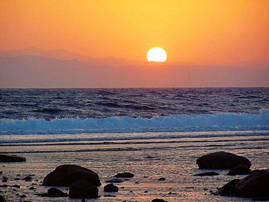 sunset, sea, water, scenics, horizon over water, tranquil scene, orange color, beauty in nature, tranquility, sun, beach, idyllic, sky, shore, nature, reflection, silhouette, rock - object, remote, non-urban scene