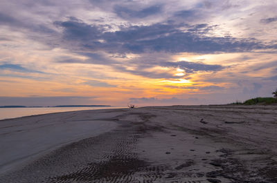 Scenic view of beach against sky during sunset